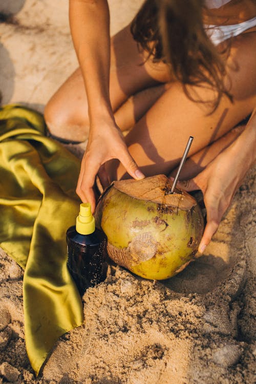 Free Person Holding Fresh Coconut with Straw Stock Photo