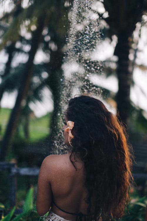Free Back View of a Woman Taking a Shower Stock Photo