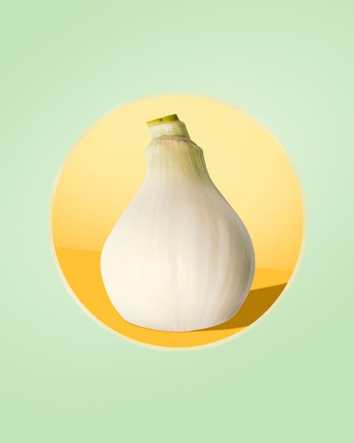 Free Photograph of an Onion on a Yellow Surface Stock Photo