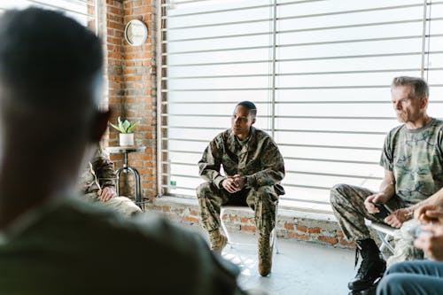 Free Photo of Soldiers Sitting on Folding Chairs Stock Photo