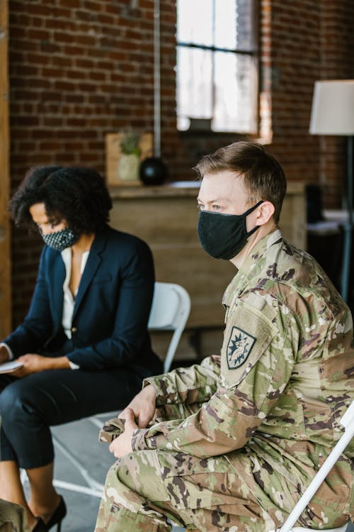 Photo of Soldier Sitting Beside a Psychologist