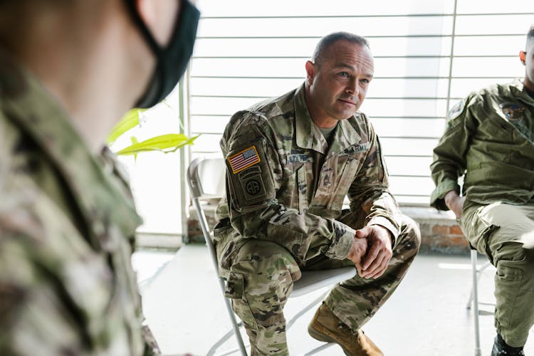 Photo Of Soldiers Sitting On Folding Chairs