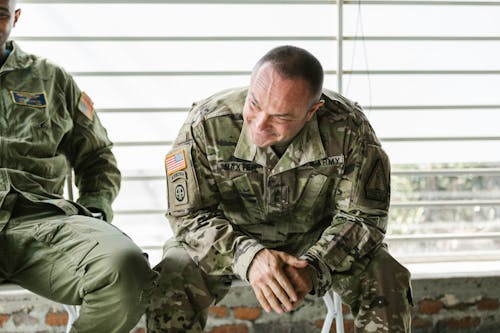 Free Photo of Soldier Actively Listening to his Comrades Stock Photo