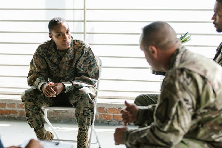 Photo Of Soldier Actively Listening To Her Comrade