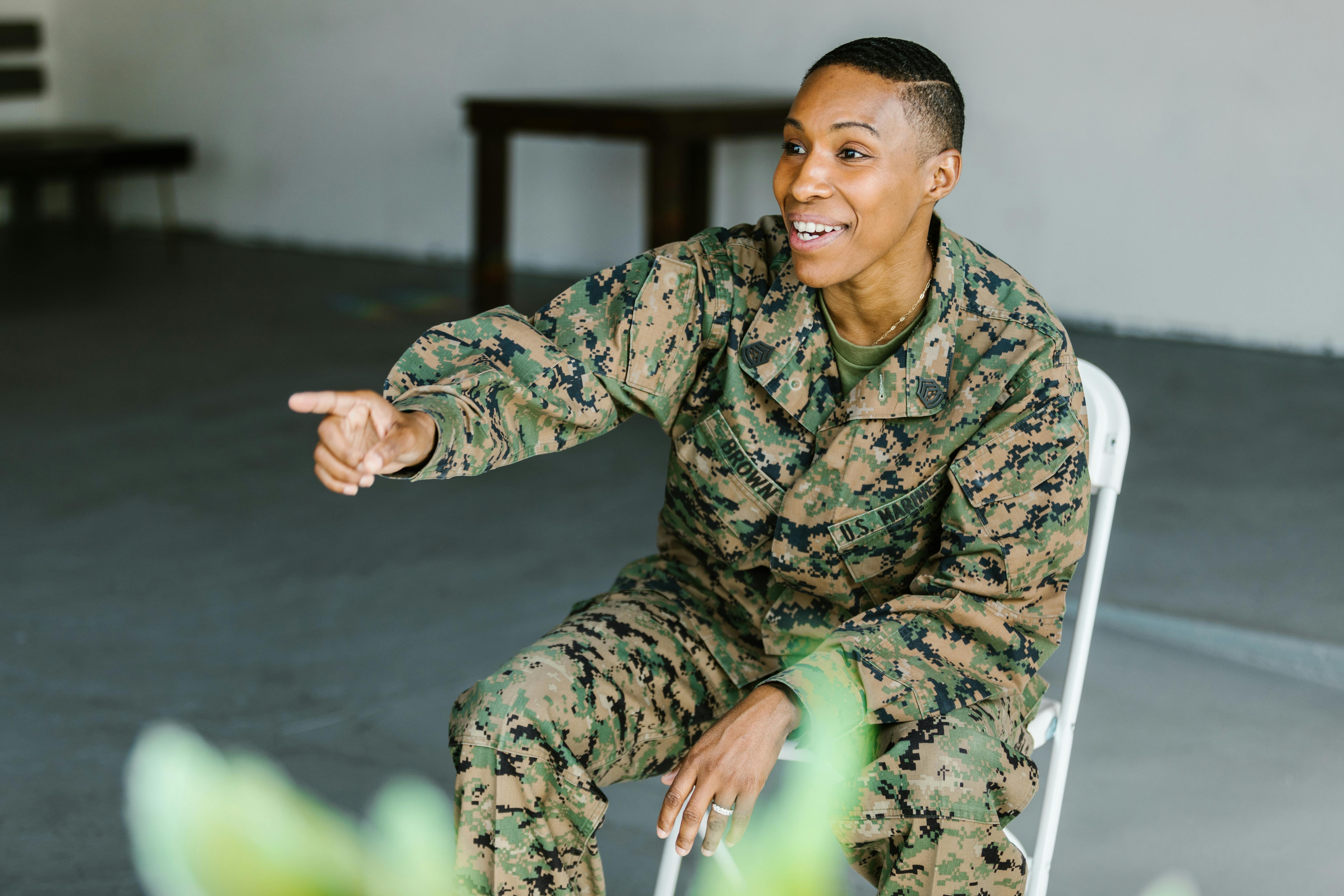 photo of soldier in military uniform sitting on a folding chair