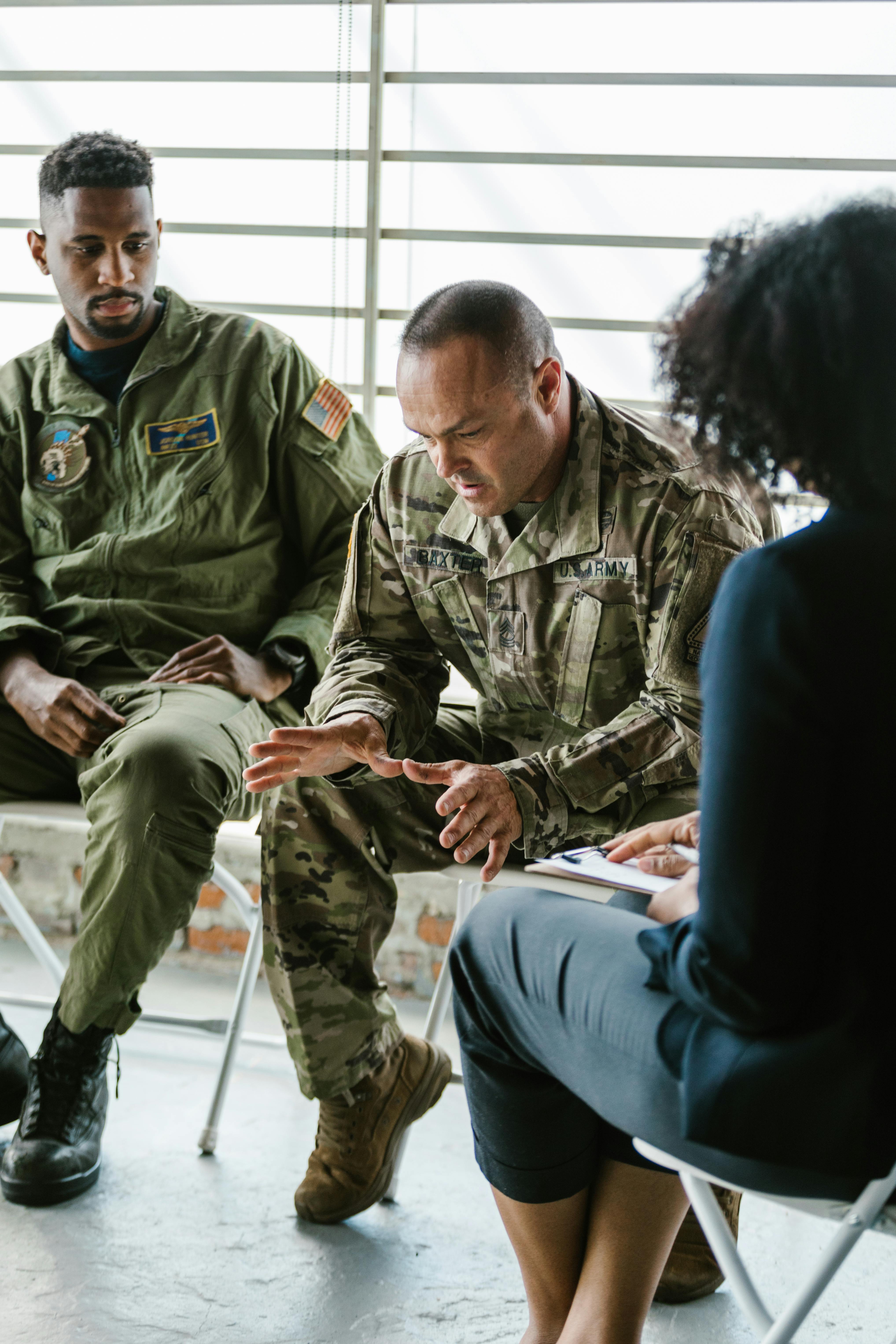 photo of soldier looking down while talking