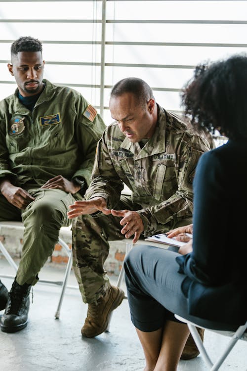 Photo of Soldier Looking Down while Talking