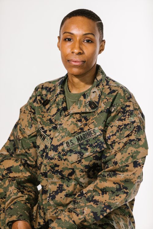 Free Confident African American woman in US Marine uniform against white background. Stock Photo