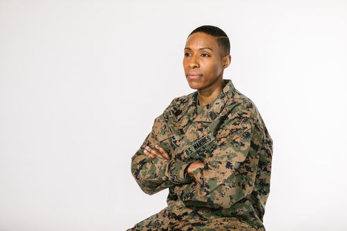Free Portrait of a confident female soldier in camouflage uniform on a white background. Stock Photo