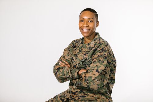 Free Confident African American female Marine smiling, showcasing pride and strength in her military role. Stock Photo