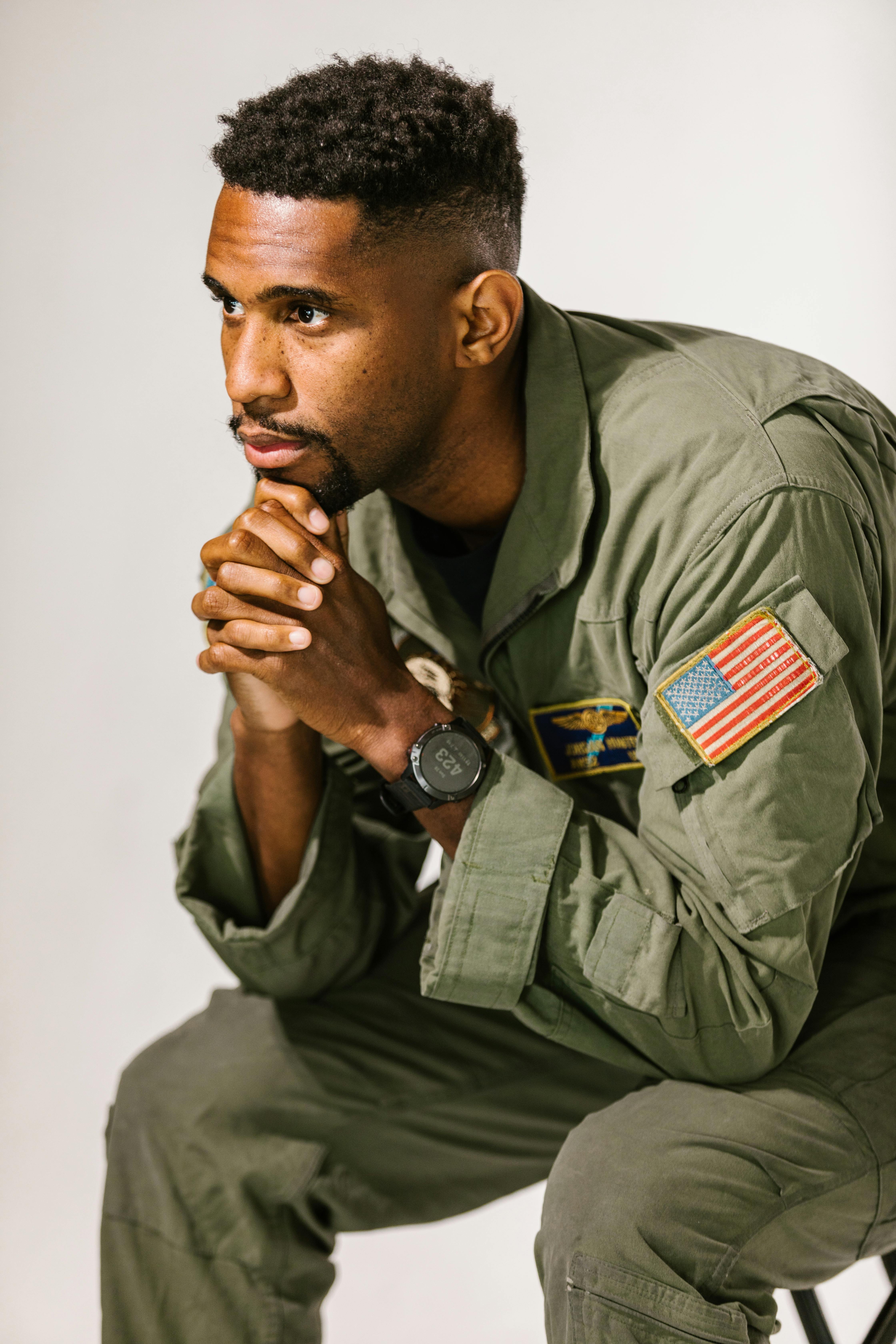 photo of soldier resting head on his hands