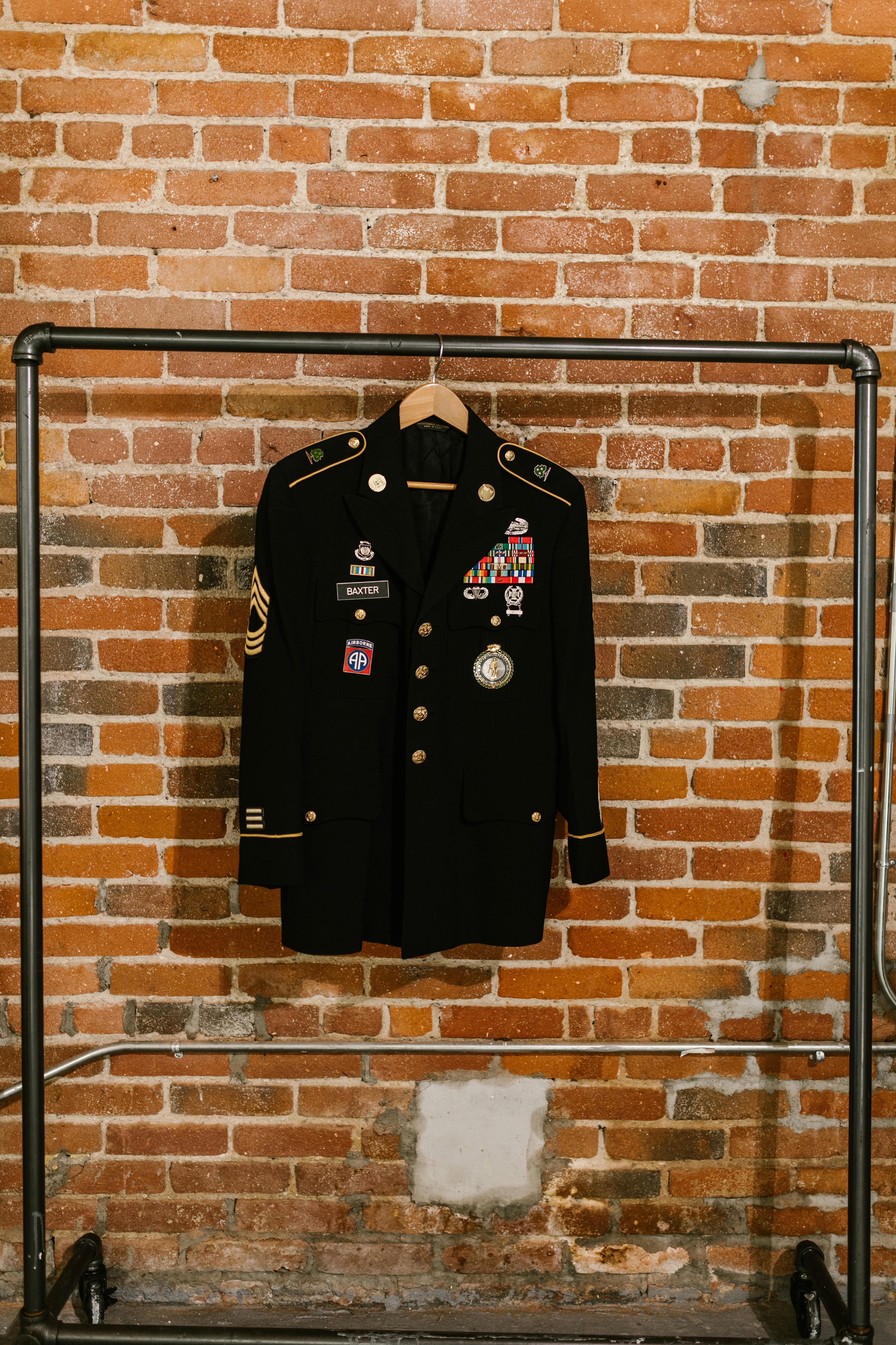 photo of black blazer hanging on a clothing rack