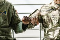 Close-Up Photo of Soldiers Doing a Fist Bump