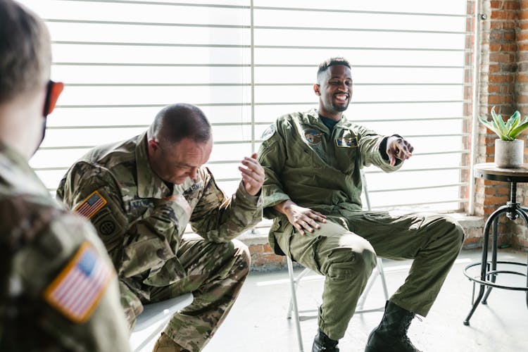 Photo Of Soldiers Sitting On Folding Chairs