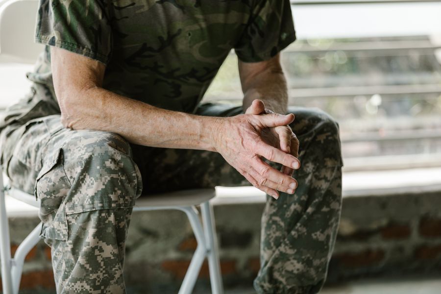 Close-up of a veteran's hands during a counseling session, emphasizing mental health and disability support