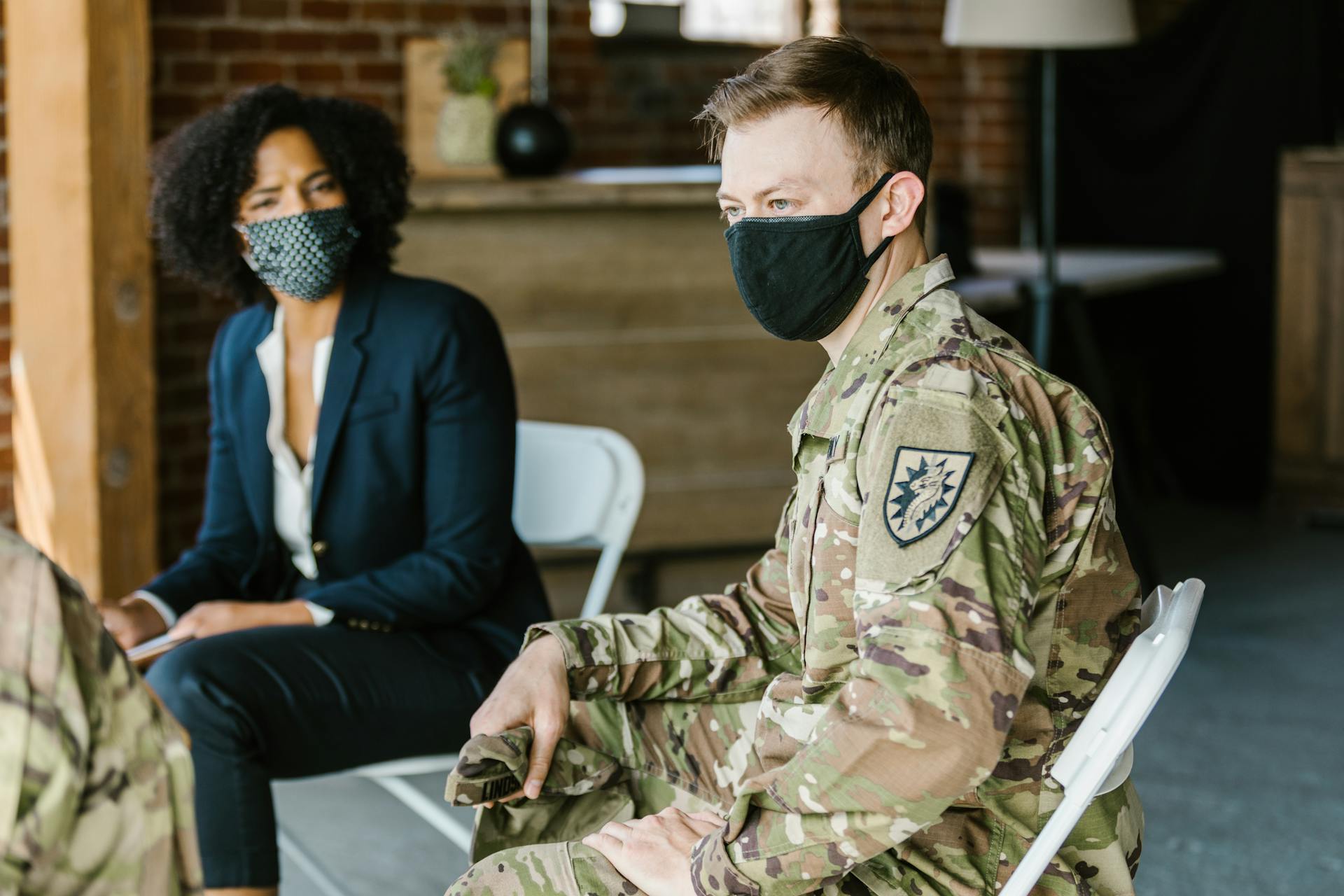 Photo of Man in Military Uniform Wearing Black Face Mask