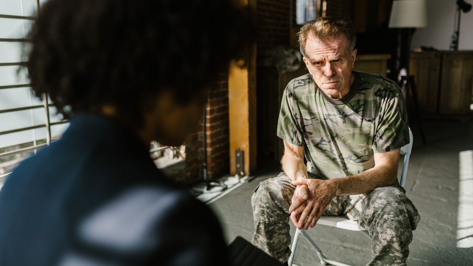 A soldier receiving counseling indoors, highlighting personal recovery.