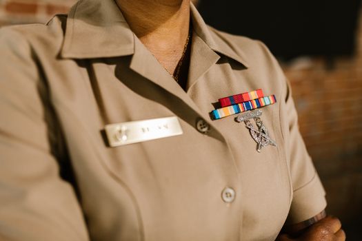 Close-Up Photo of Person Wearing Beige Military Uniform 
