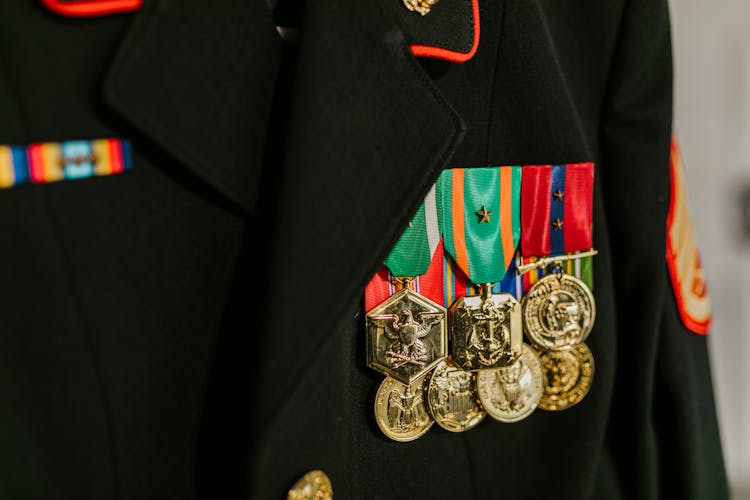 Close-Up Photo Of Navy Uniform With Gold Medals