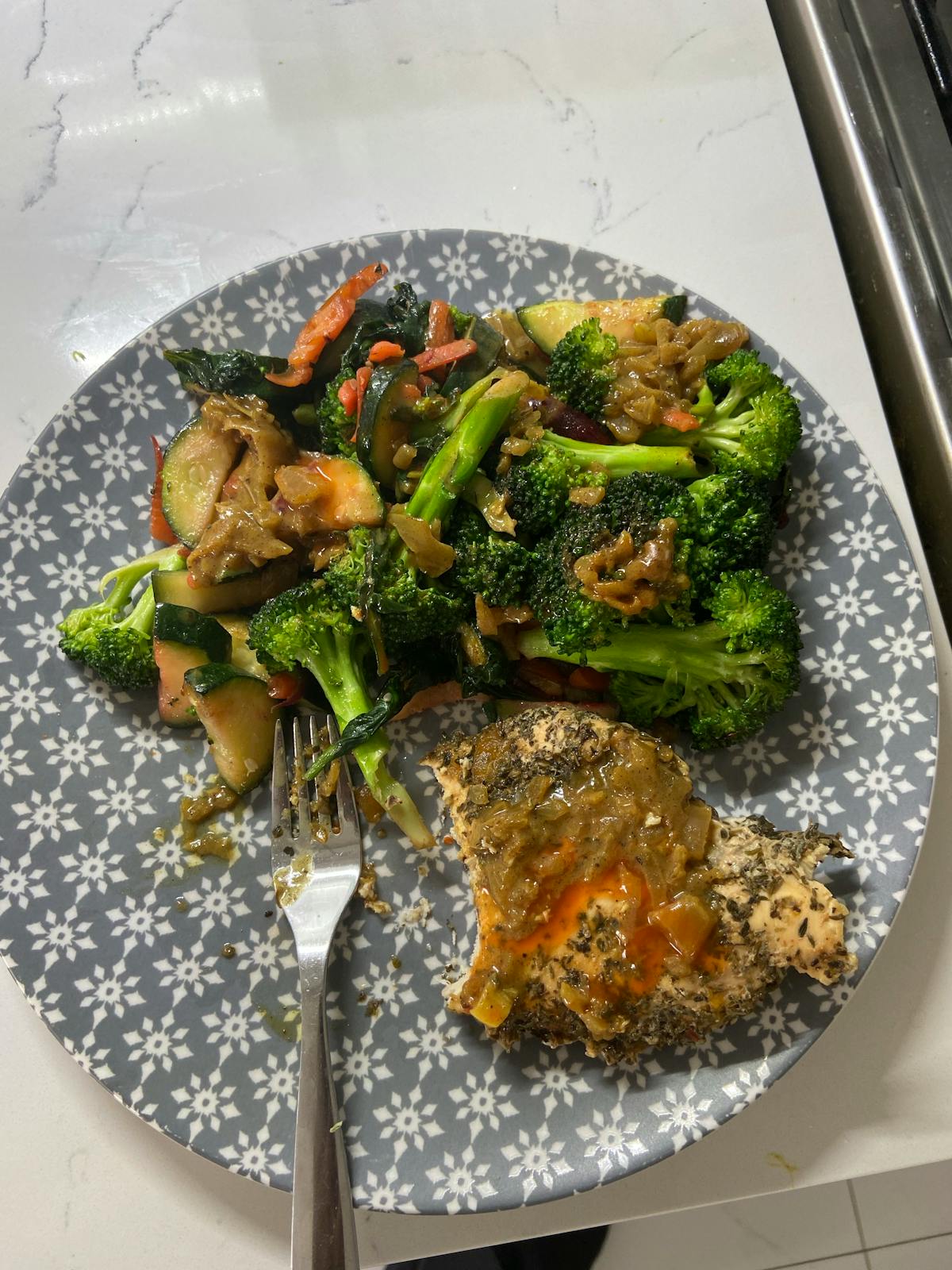 Woman sitting on bed holding lower abdomen in discomfort