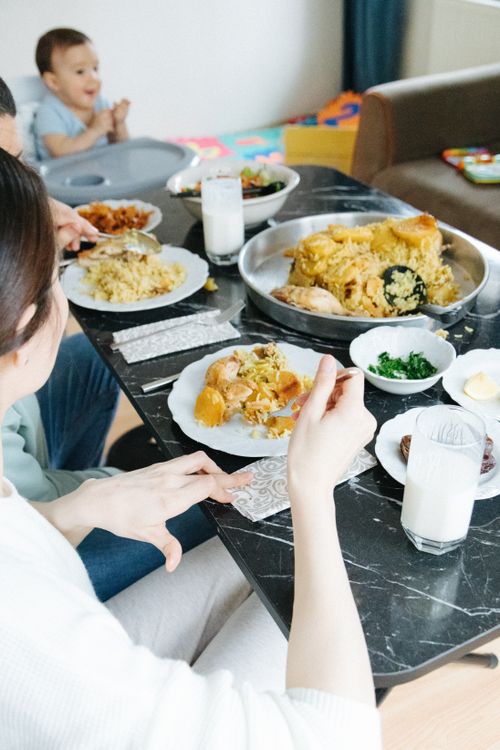 Free A family gathered around a dining table enjoying a homemade meal in İstanbul, Turkey. Stock Photo