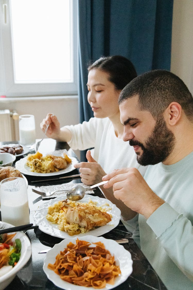 A Man And A Woman Eating Together