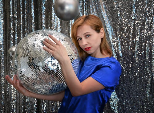 Charming woman with big disco ball