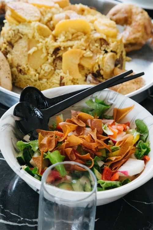 Free Close-up of a fresh salad with rice dish on a marble table, highlighting vibrant colors and textures. Stock Photo