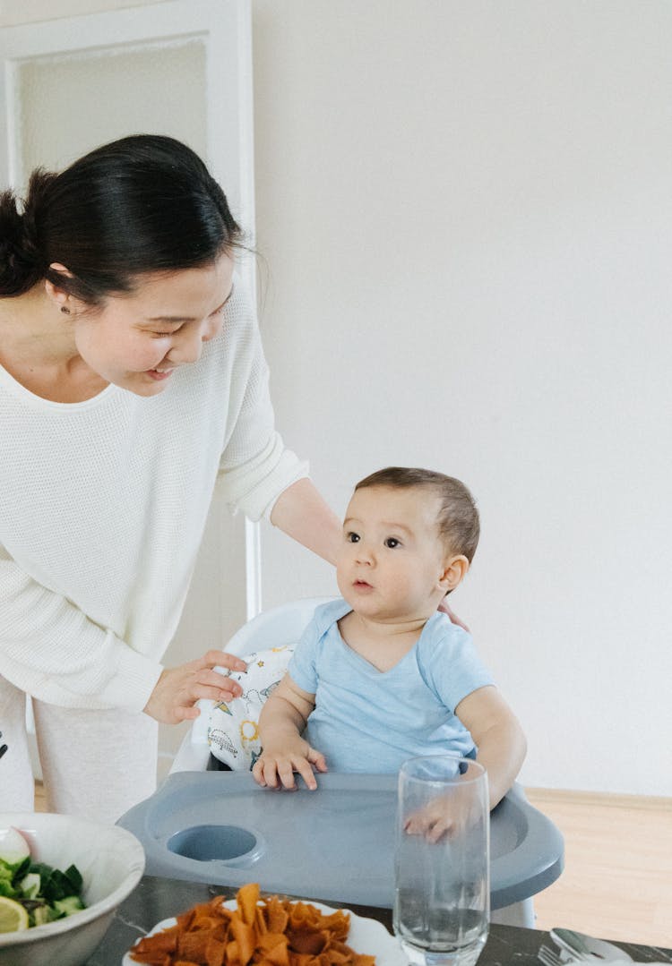 Woman With Baby Boy At Dinner Time