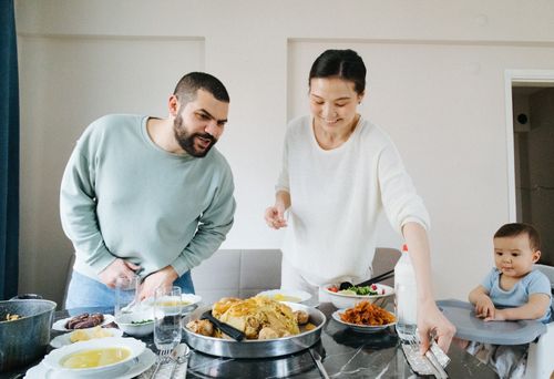 Free Family enjoying a meal together at home, celebrating with traditional dishes. Stock Photo