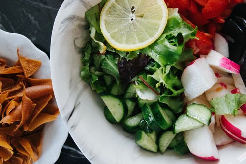 Free A fresh salad with cucumber, lettuce, and lemon served in a ceramic plate in İstanbul. Stock Photo