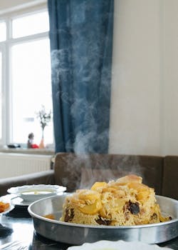 Delicious steaming rice dish served in a cozy home setting, evoking traditional Middle Eastern cuisine.