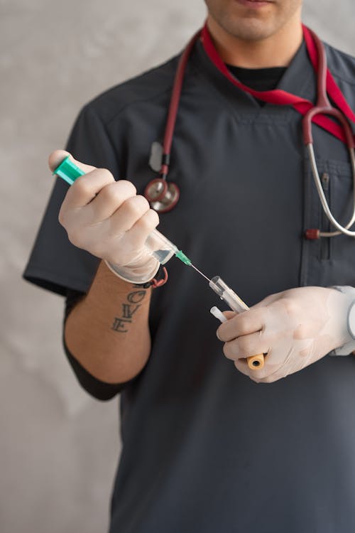 Person Holding a Syringe