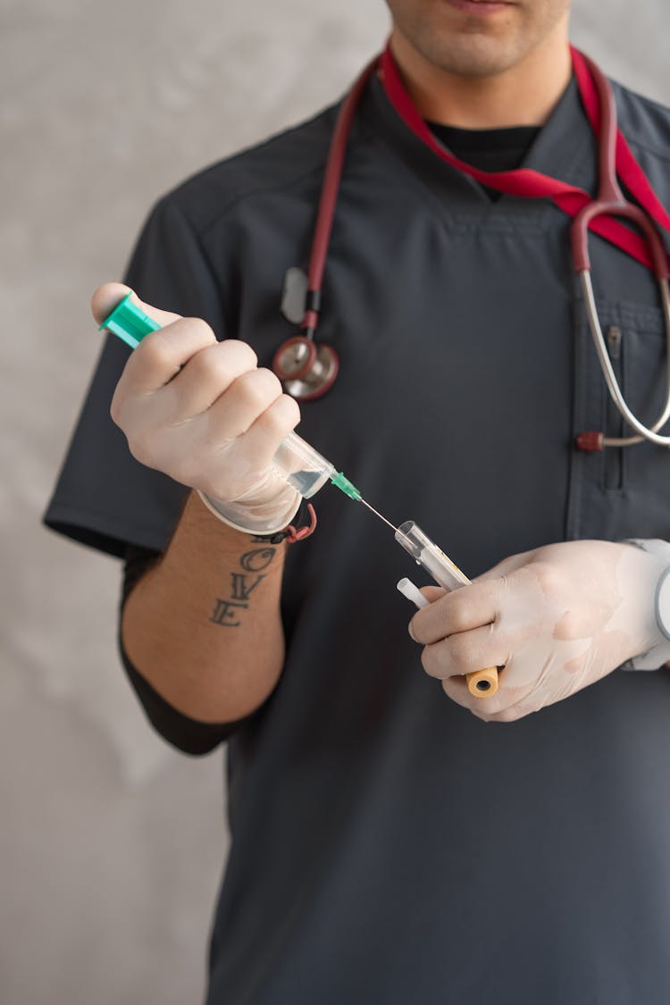 Person Holding A Syringe