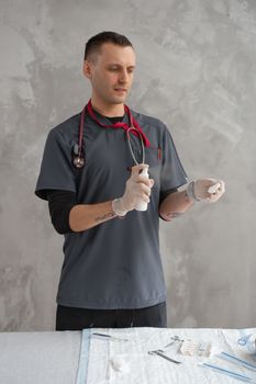 Healthcare professional wearing gloves and preparing tools for a medical procedure.