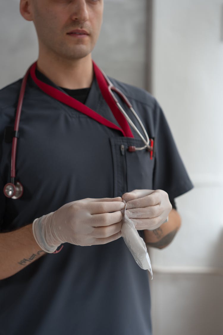 Man Opening A Sterile Gauze