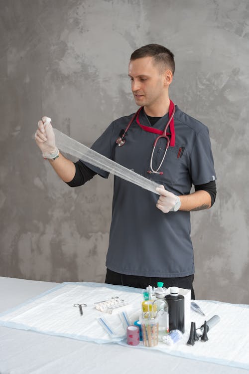 A Male Doctor Preparing a Gauze