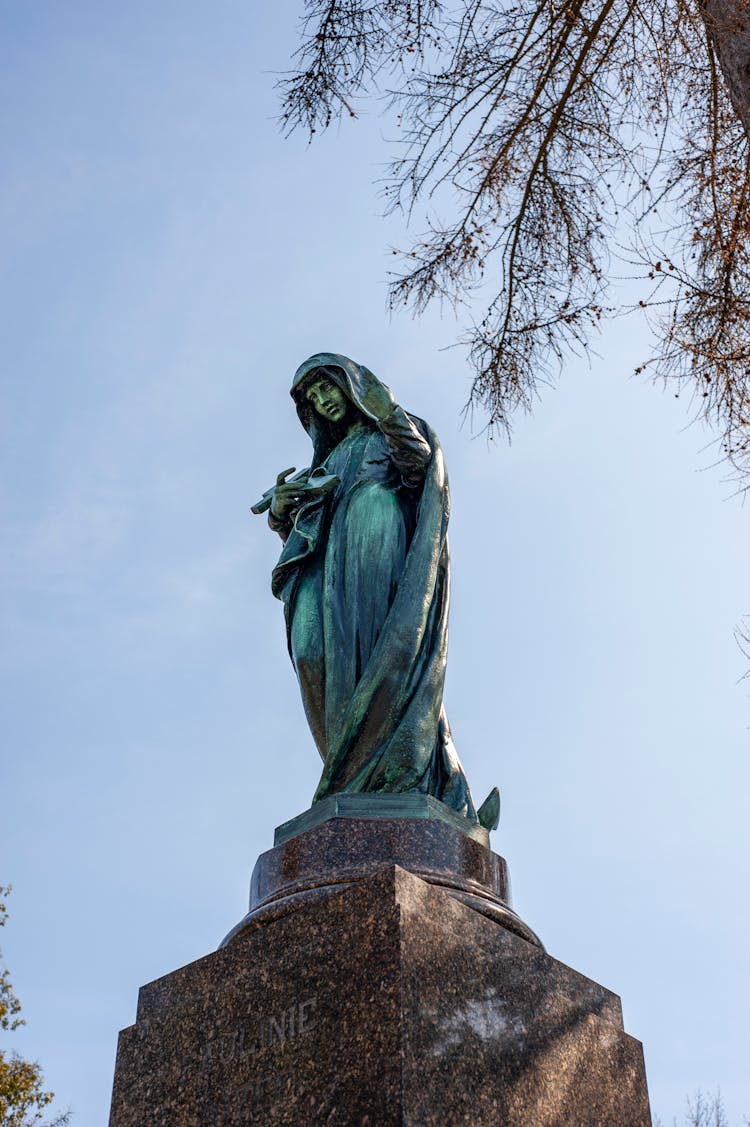 Low Angle Of Madonna Statue Covered With Green Patina