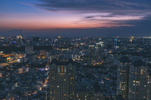 A breathtaking aerial view capturing the illuminated cityscape with vibrant skyscrapers and stunning skyline at dusk.