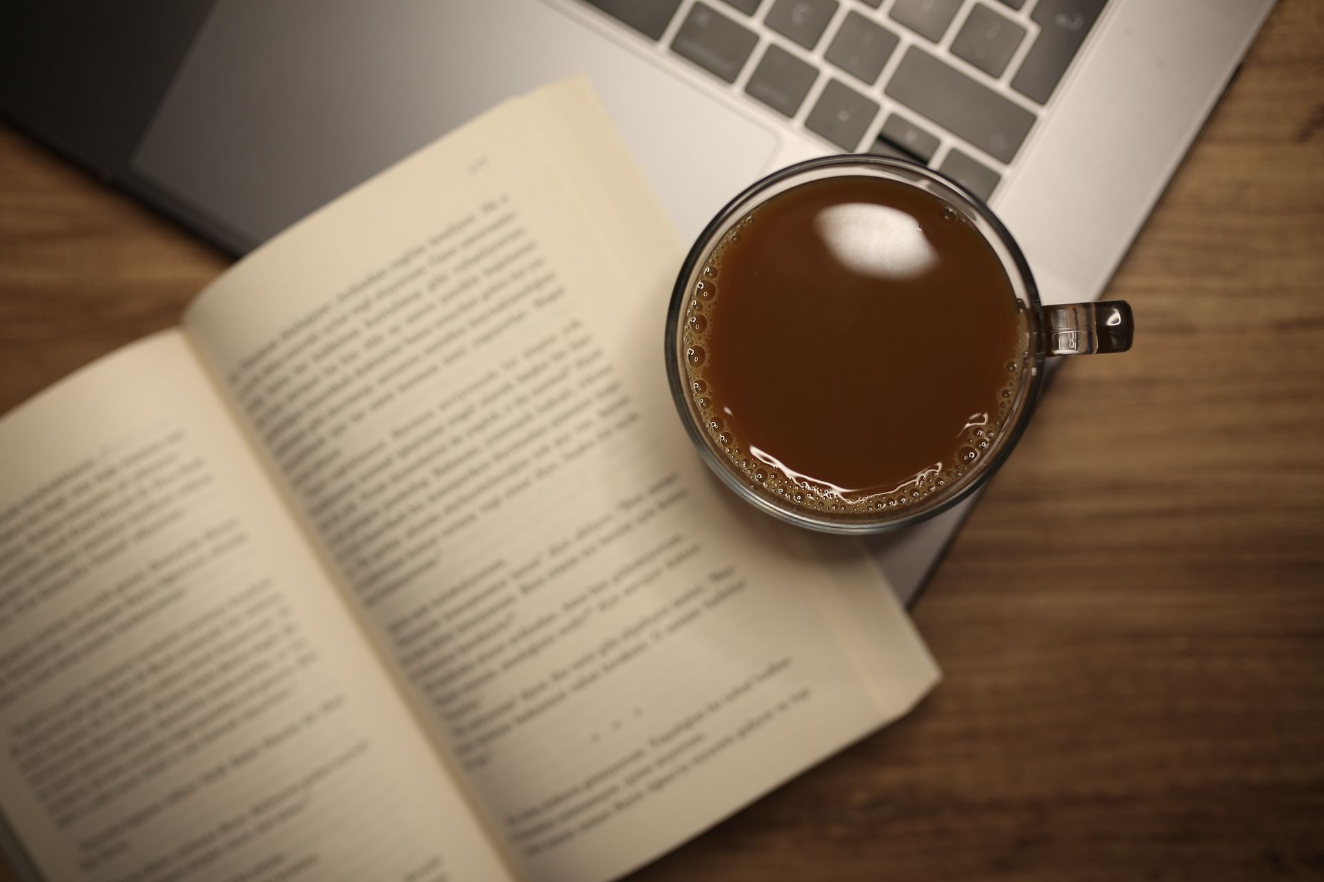 Overhead Shot of a Glass Mug Near a Book