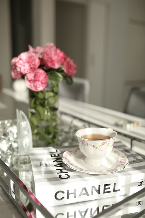 Roses on table near cup of tea