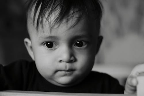 Grayscale Photo of a Cute Child