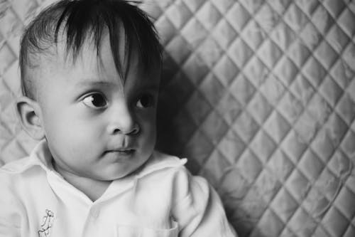 Grayscale Photo of a Cute Child