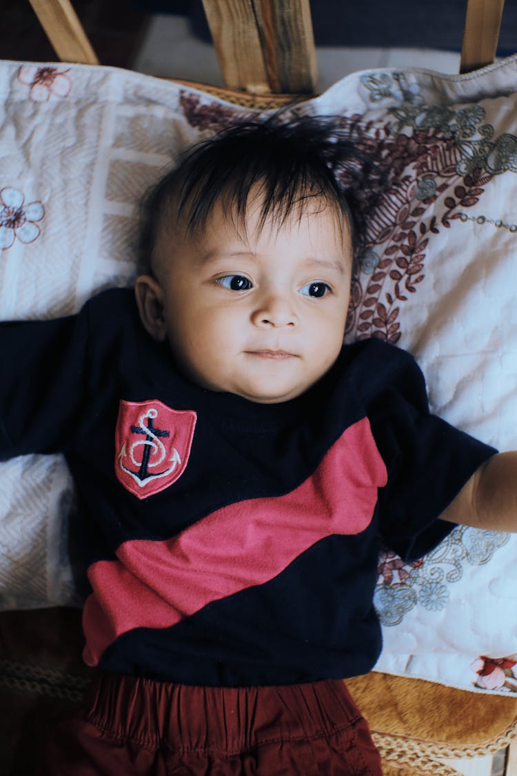 Cute Ethnic Baby Lying In Crib