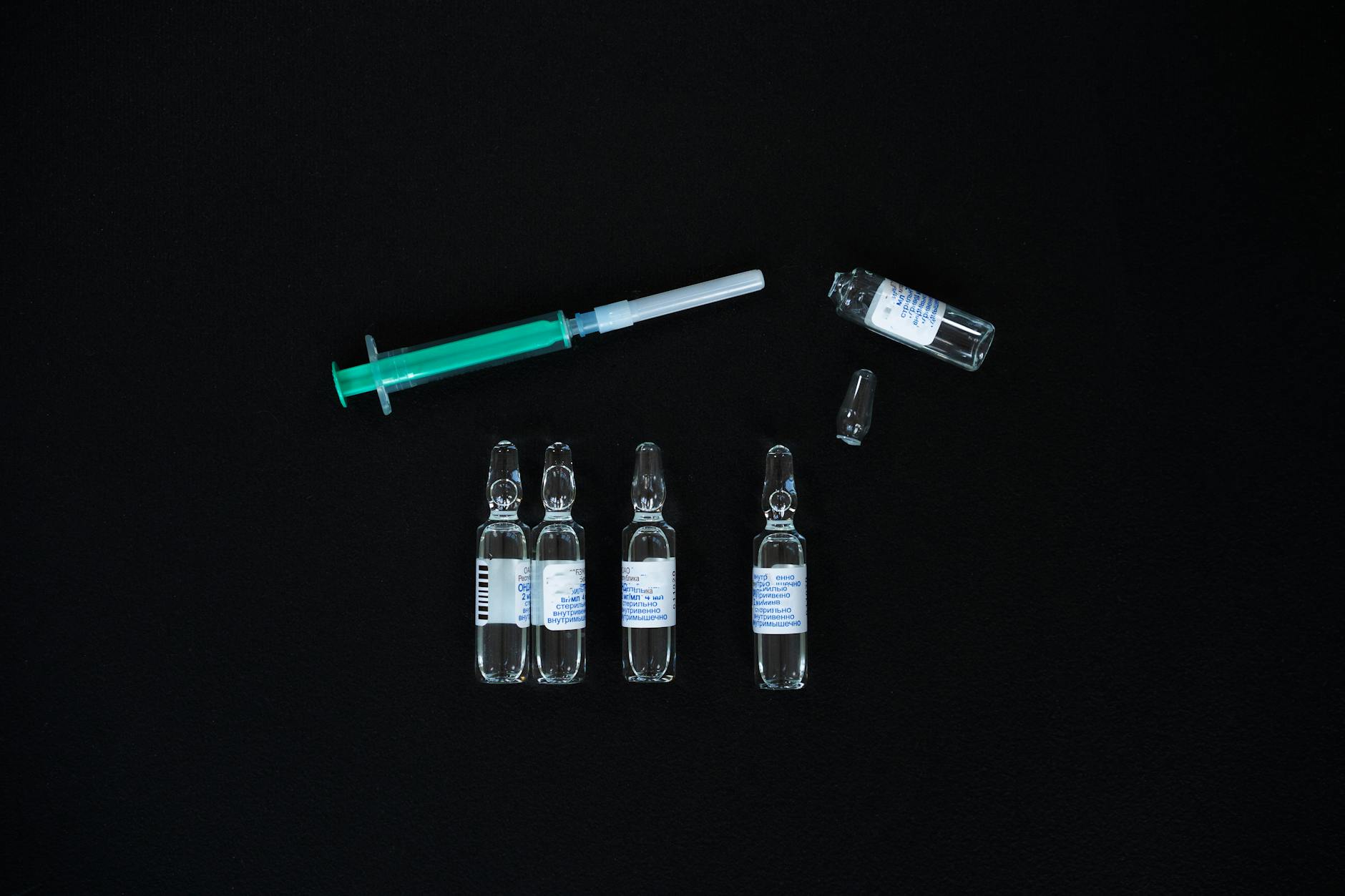 3 Bottles With Green and White Tube