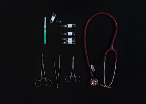 Free Flat lay of medical equipment including stethoscope, syringe, and tools. Stock Photo