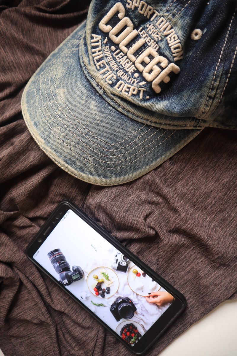 A denim cap resting on folded fabric — photo by Vintage on Pexels