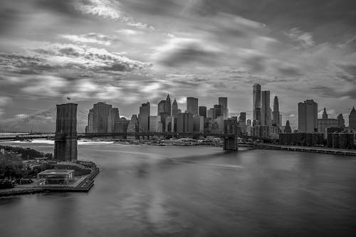 Grayscale Photography of City Buildings and Bridge