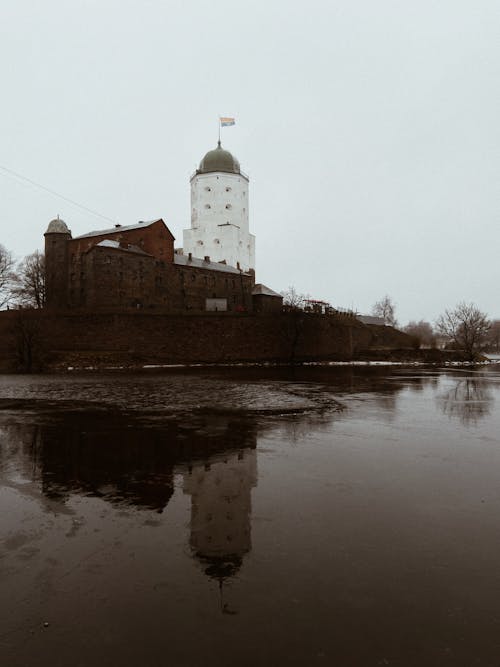 White Tower with Flag Reflecting on River 