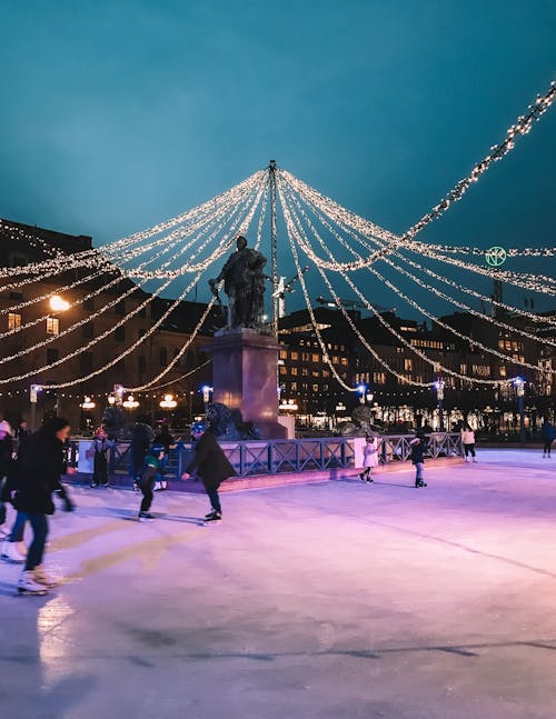 People on Ice Skating Rink during Night Time